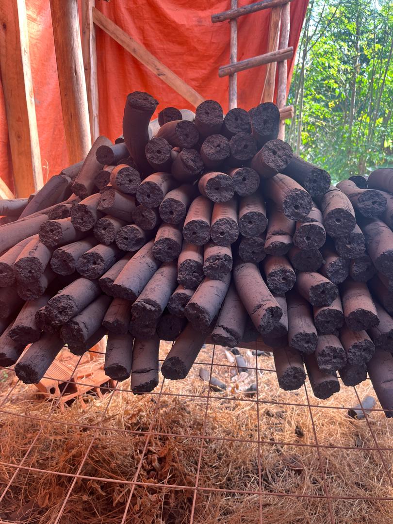 Stack of stick briquettes — outdoor storage at production facility